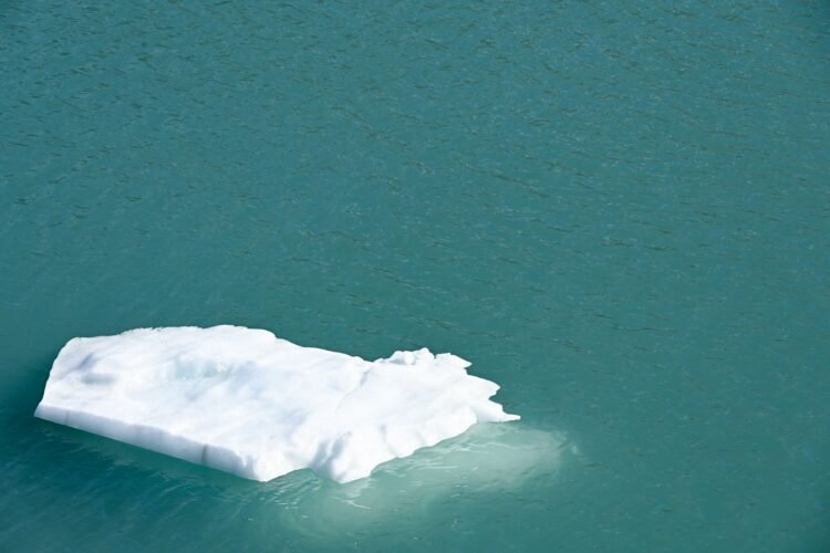Bloque de hielo desprendiéndose de un glaciar en la Antártida, región afectada por contaminación por mercurio.