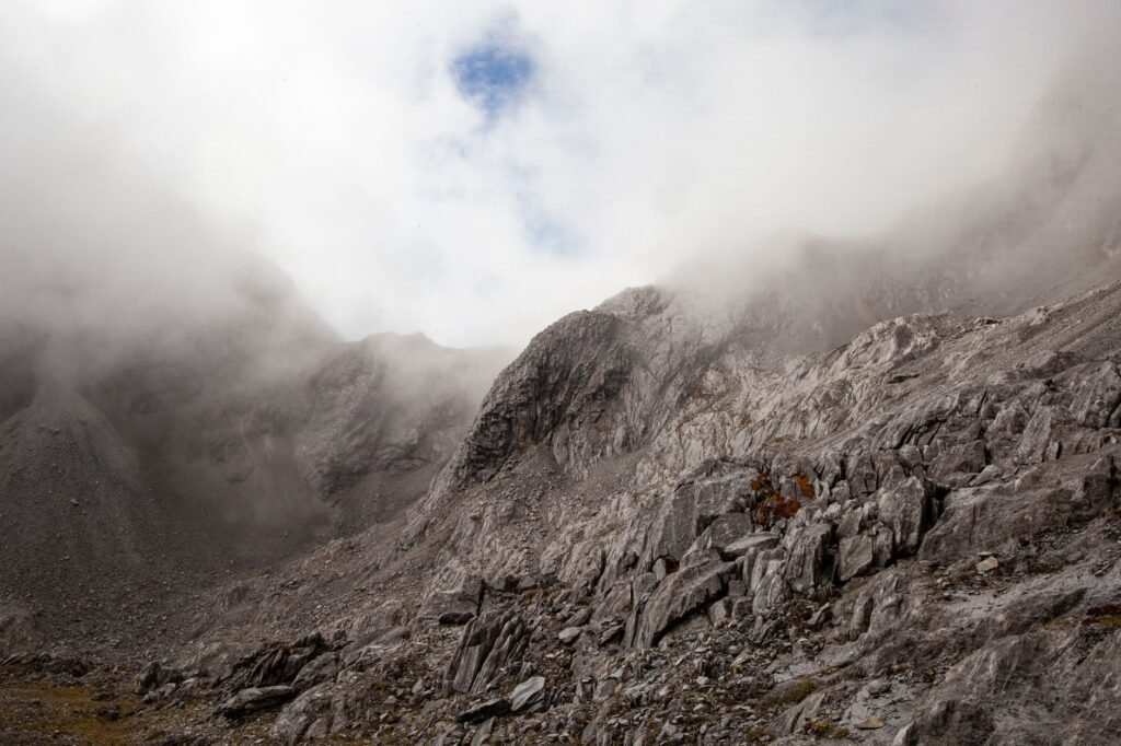 Valle de montaña cubierto de lodo y escombros tras un alud en región del Himalaya.