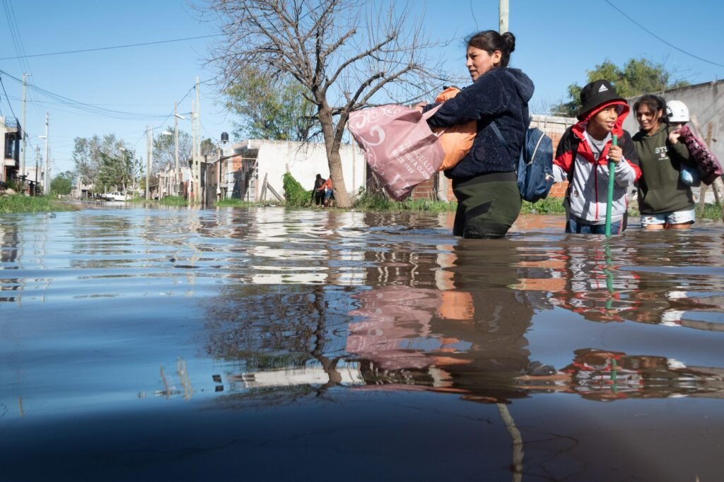 Calle cubierta de lodo y escombros tras una riada en una localidad rural, similar a la que devastó Manzanedo en León.
