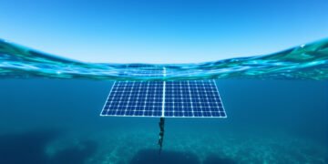 Panel solar bajo el agua con luz azul filtrada por el océano, mostrando tecnología fotovoltaica submarina.