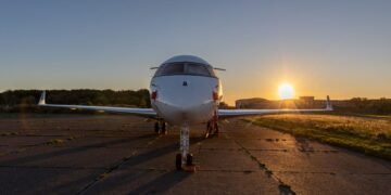 Silueta de un jet privado en la pista de aterrizaje al atardecer, símbolo de las emisiones desproporcionadas de la aviación p