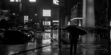 Peatones cruzan bajo la lluvia en un cruce de Tokio, Japón, durante la racha récord de precipitaciones.