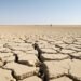 Campo agrícola europeo agrietado por sequía extrema durante las olas de calor del verano 2026.